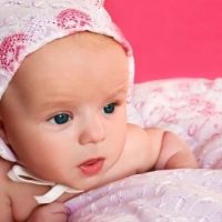 newborn girl with pink hat